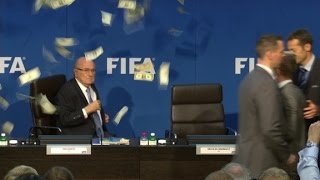 Comedian throws money at Blatter during press conference [upl. by Aicnerolf818]